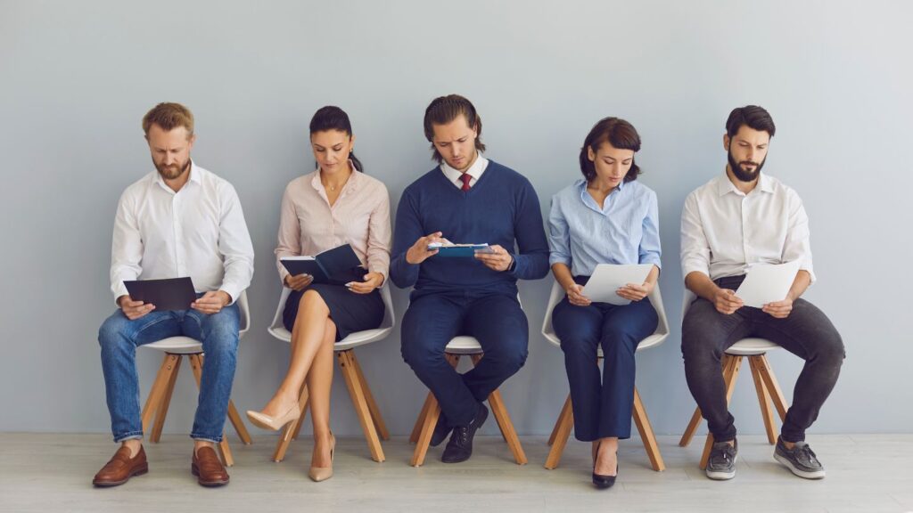 Group Of Job Applicants Waiting In A Row During An Interview Session