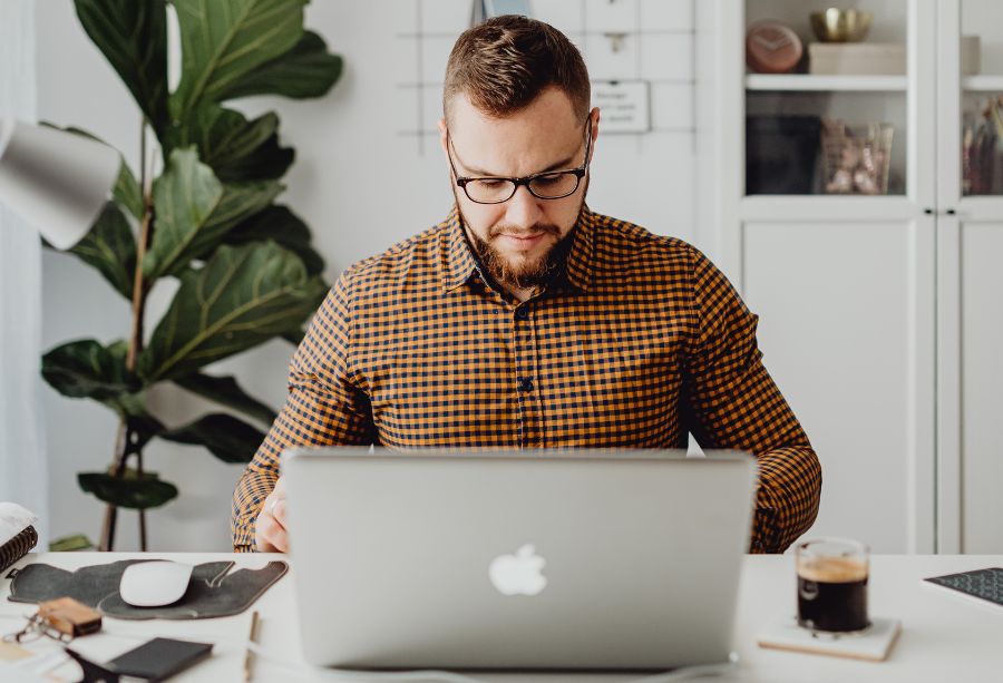 Man Working On Laptop In Office