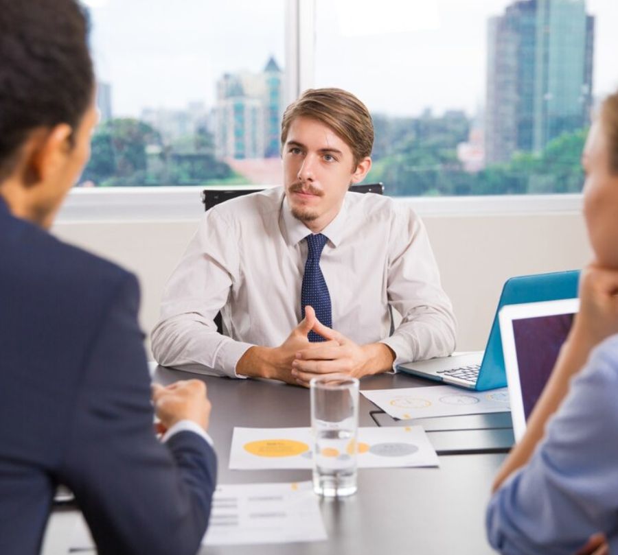 Three Professionals In A Business Meeting