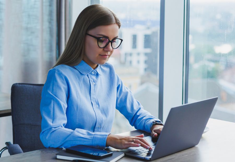 Woman Typing On A Laptop