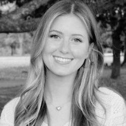 Black-and-white portrait of smiling woman outdoors